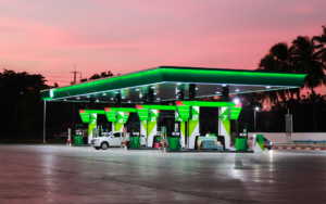 Gas Station Glowing Under A Pink Sunset Sky At Dusk