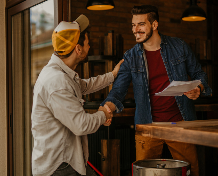 Two Men Shaking Hands In Restaurant